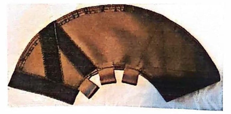 Tan and black fabric cover laid flat in a fan shape, with dark strips across one side and three small tabs along the curved inner edge.